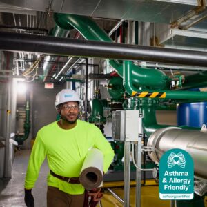 Contractor installing Knauf Performance+® commercial insulation, Certified Asthma & Allergy Friendly® for better indoor air quality.