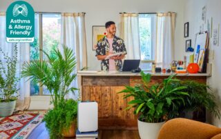 Alen BreatheSmart 25i air purifier, Certified Asthma & Allergy Friendly®, improving indoor air quality in a home office with plants and natural light.