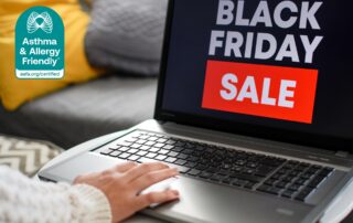 Person shopping online for Black Friday deals on a laptop, shown alongside the Asthma & Allergy Friendly® Certification mark.