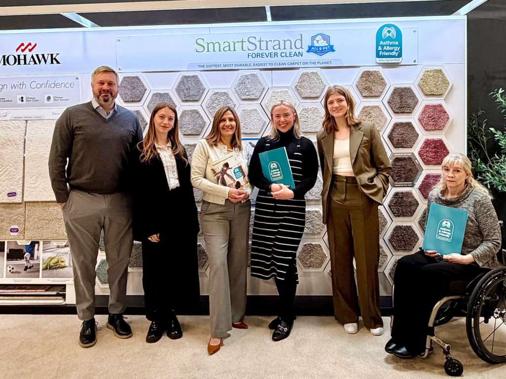 Leah McInerney and Gemma Cox with Mohawk Industries team showcasing Certified SmartStrand carpet for healthier indoor environments