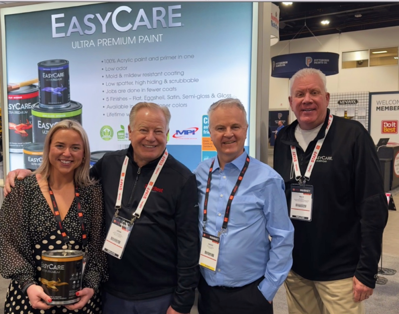 Leah McInerney with John Vanderpool, Dave Morrissey and Rich White at the True Value EasyCare paint booth during the Do it Best & True Value Spring Market